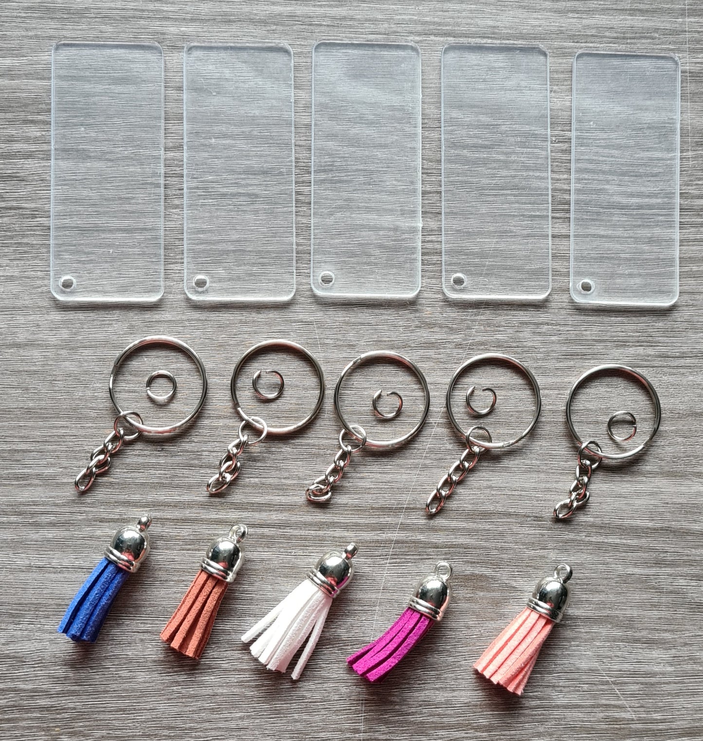 Set of 5 rectangular acrylic key rings with tassels and chain.